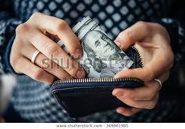 Hands holding us dollar bills and small money pouch | jobs in Canada